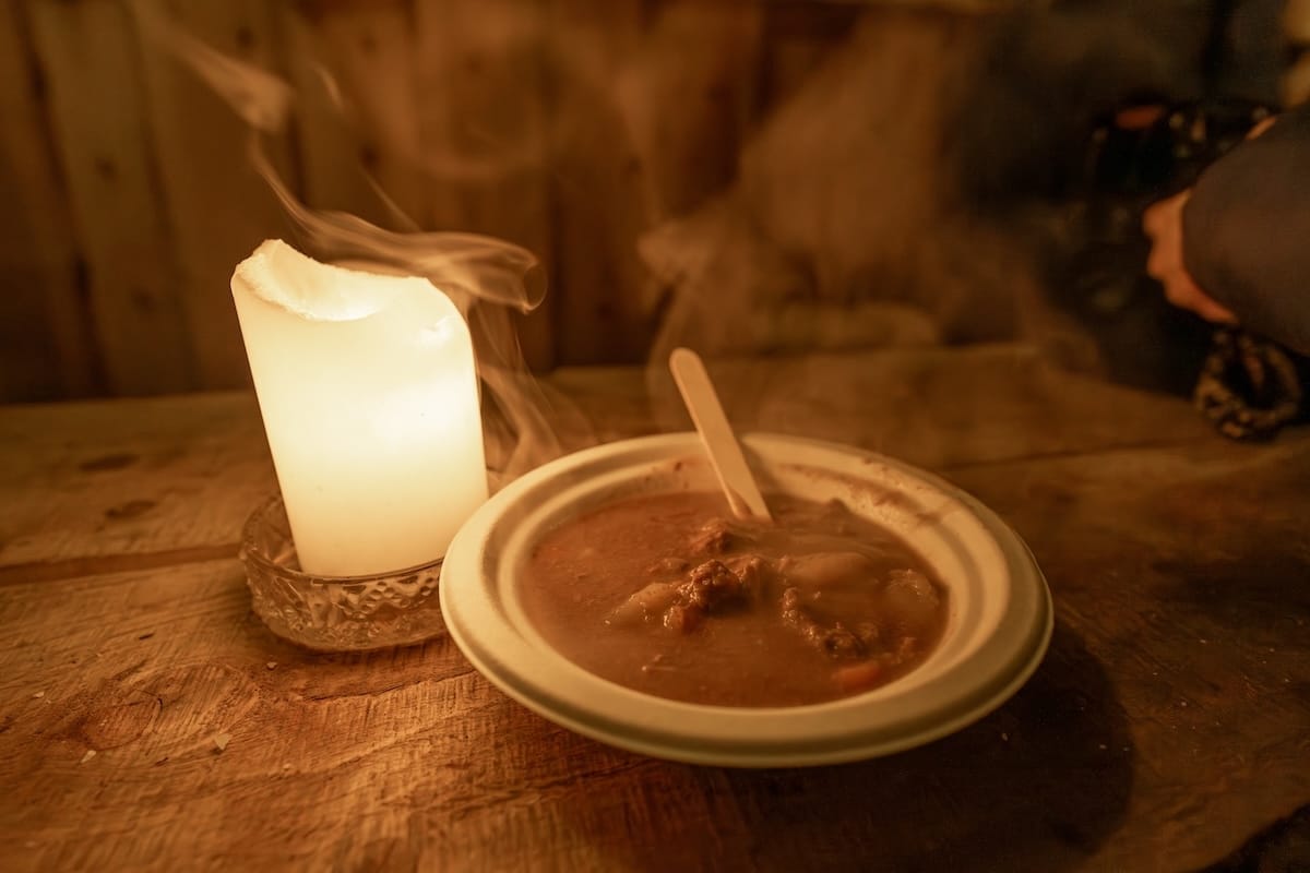 A photo of Bidos stew, a Sami traditional dish, inside a Lavvu in Tromsø, Norway