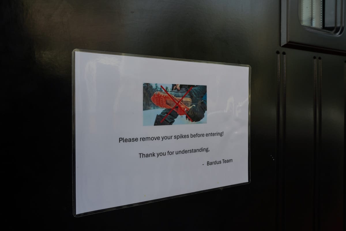 a sign asking people to remove spikes from their shoes in Tromsø