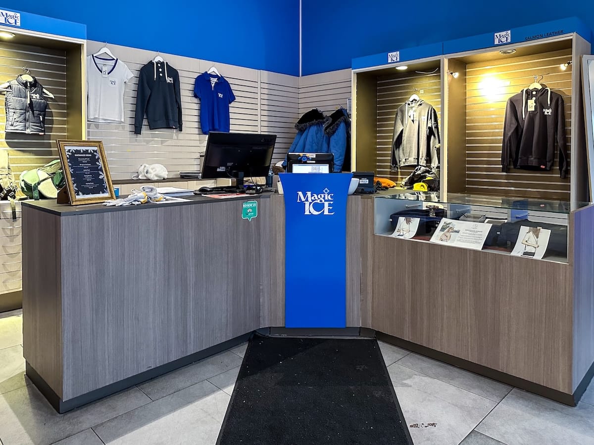 reception area at magic ice bar with a large desk, merch behind it