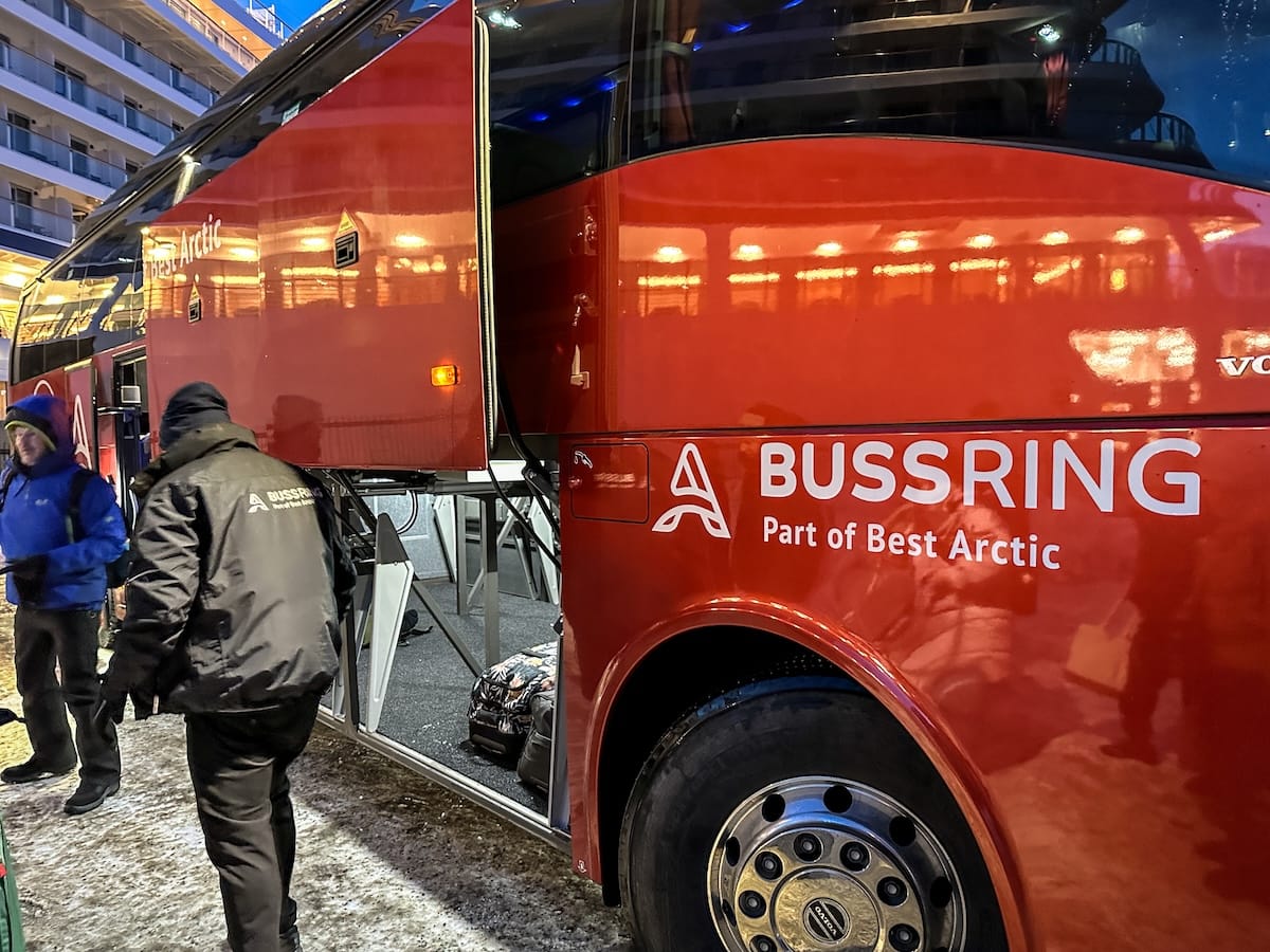 The Best Arctic bus that goes from Tromsø to Rovaniemi

a red bus having luggage loaded below it in norway