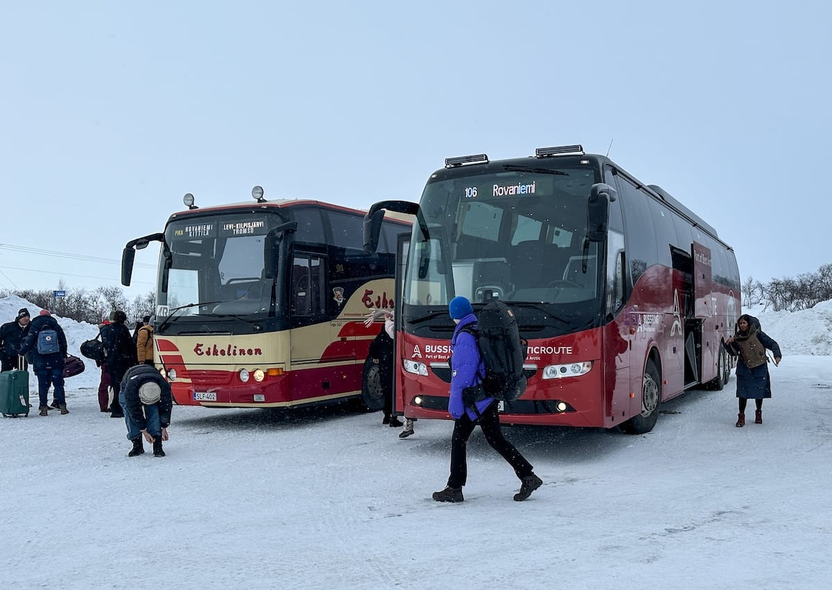 two buses with passengers switching between them in finland