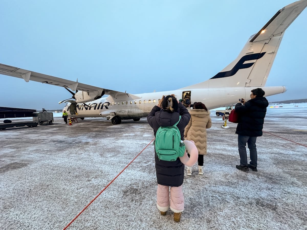 Boarding a plane from Rovaniemi to Tromsø

a photo of a finnair plane outside in winter with passengers getting on